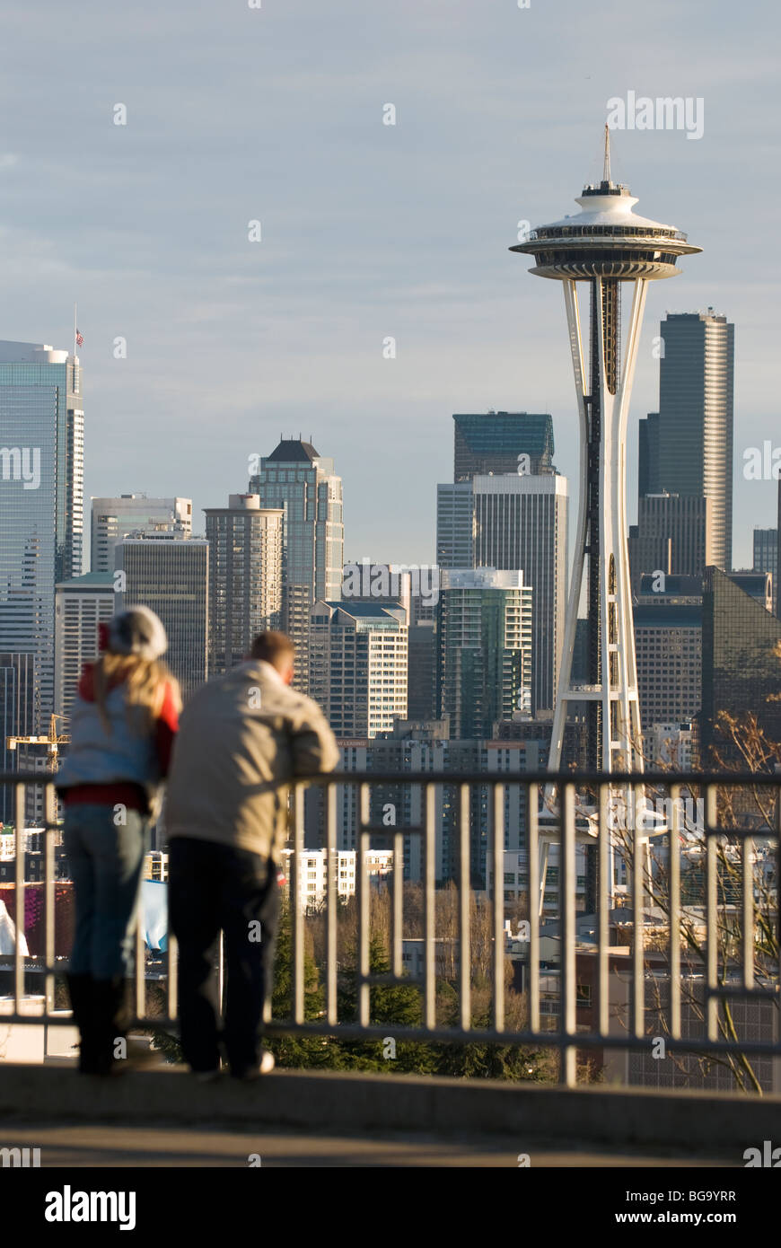A couple enjoy the view of downtown Seattle and the space needle from Kerry Park. Stock Photo