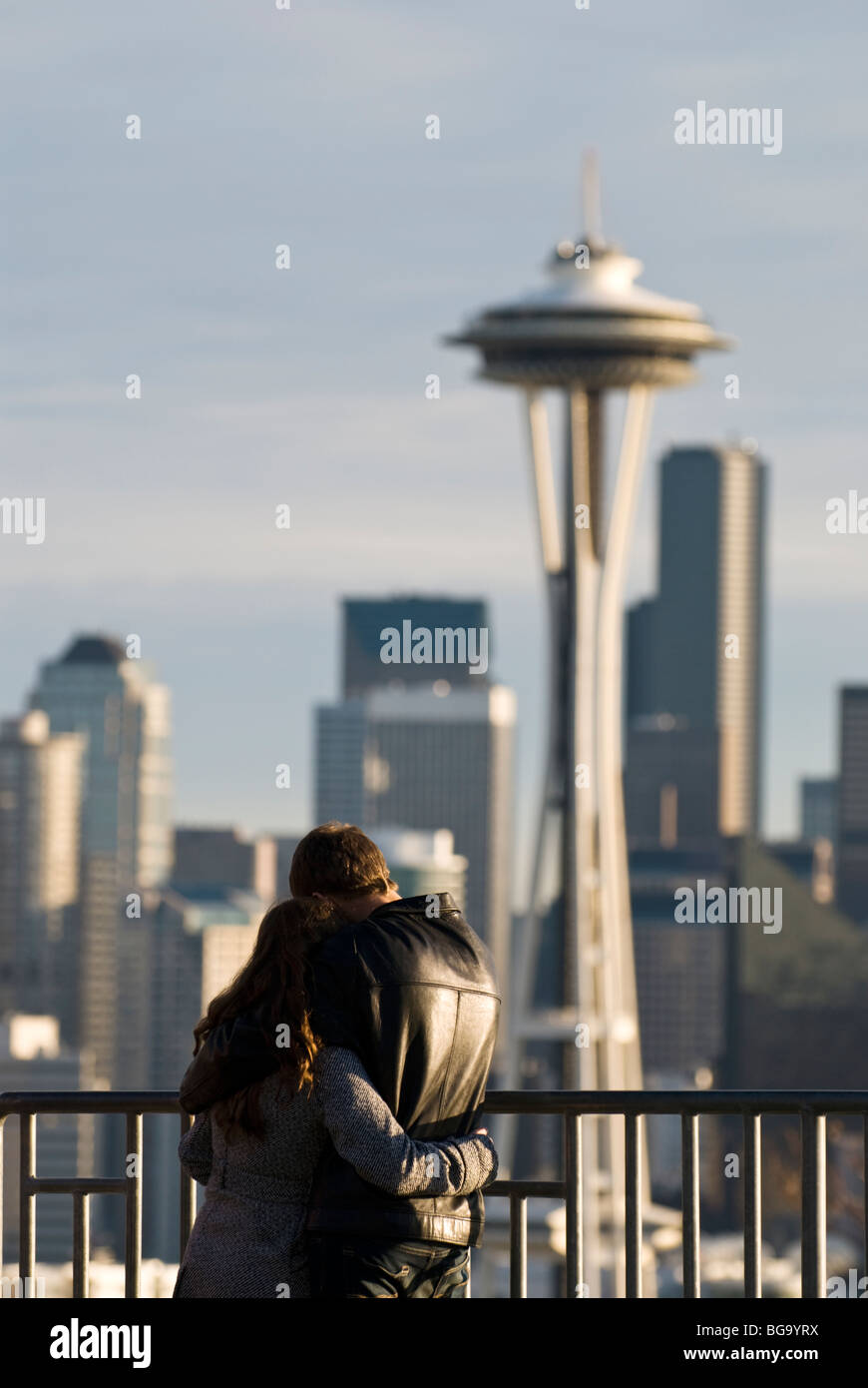 A couple enjoy the view of downtown Seattle and the space needle from Kerry Park. Stock Photo