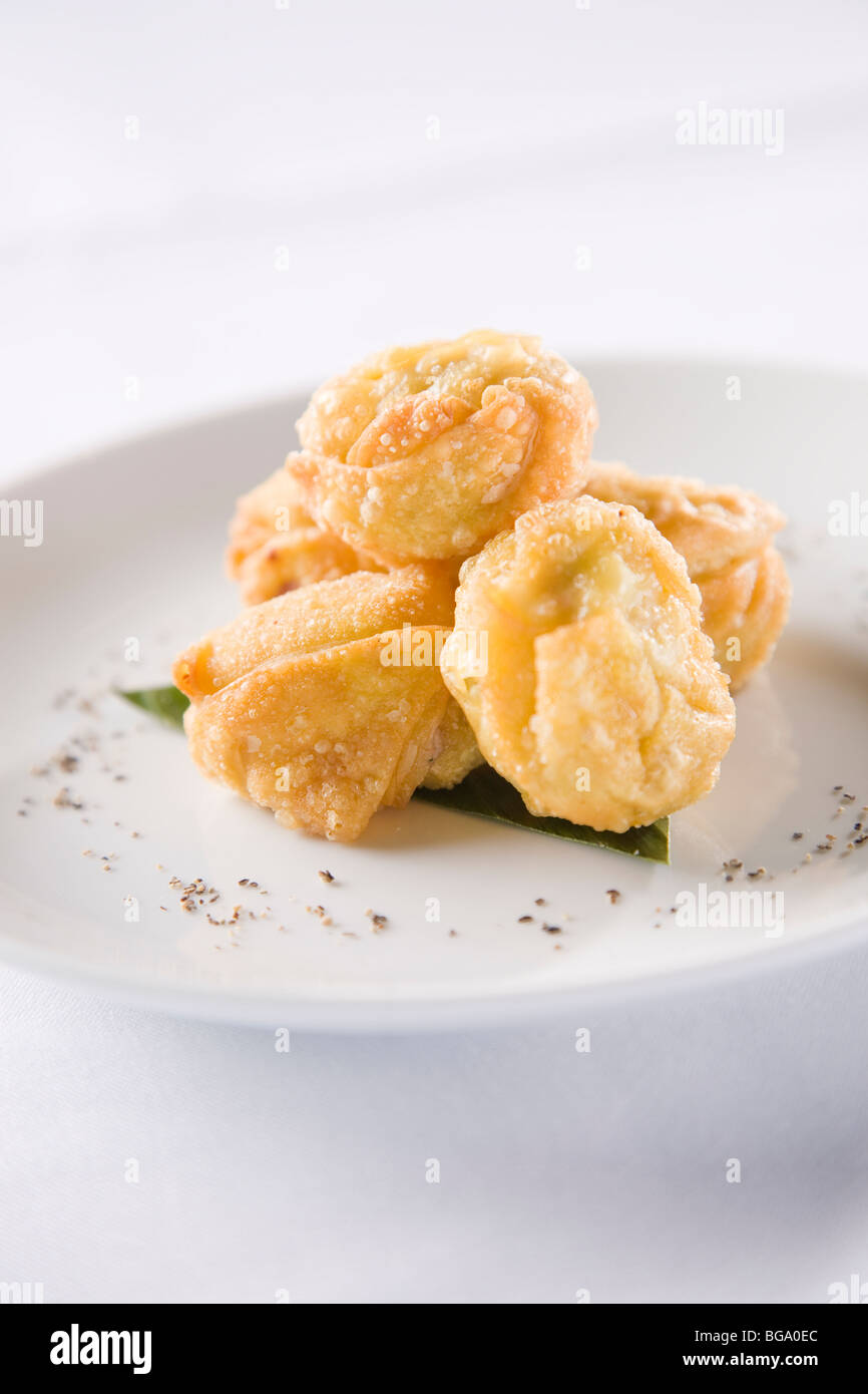 Five curry puffs on white plate. Stock Photo