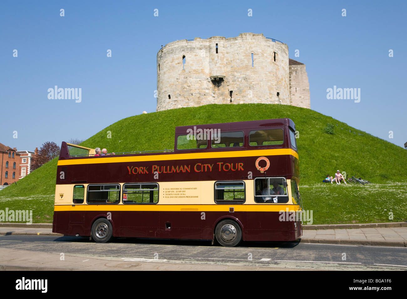 Pullman bus in York in front of Cliffords tower, North Yorkshire Stock Photo