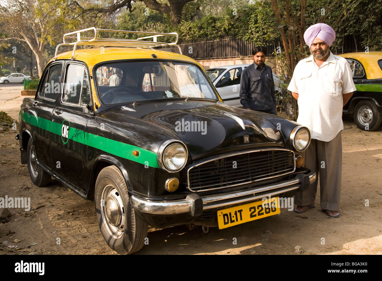 A Sikh taxi driver stands by his black taxi in New Delhi, India. Stock Photo