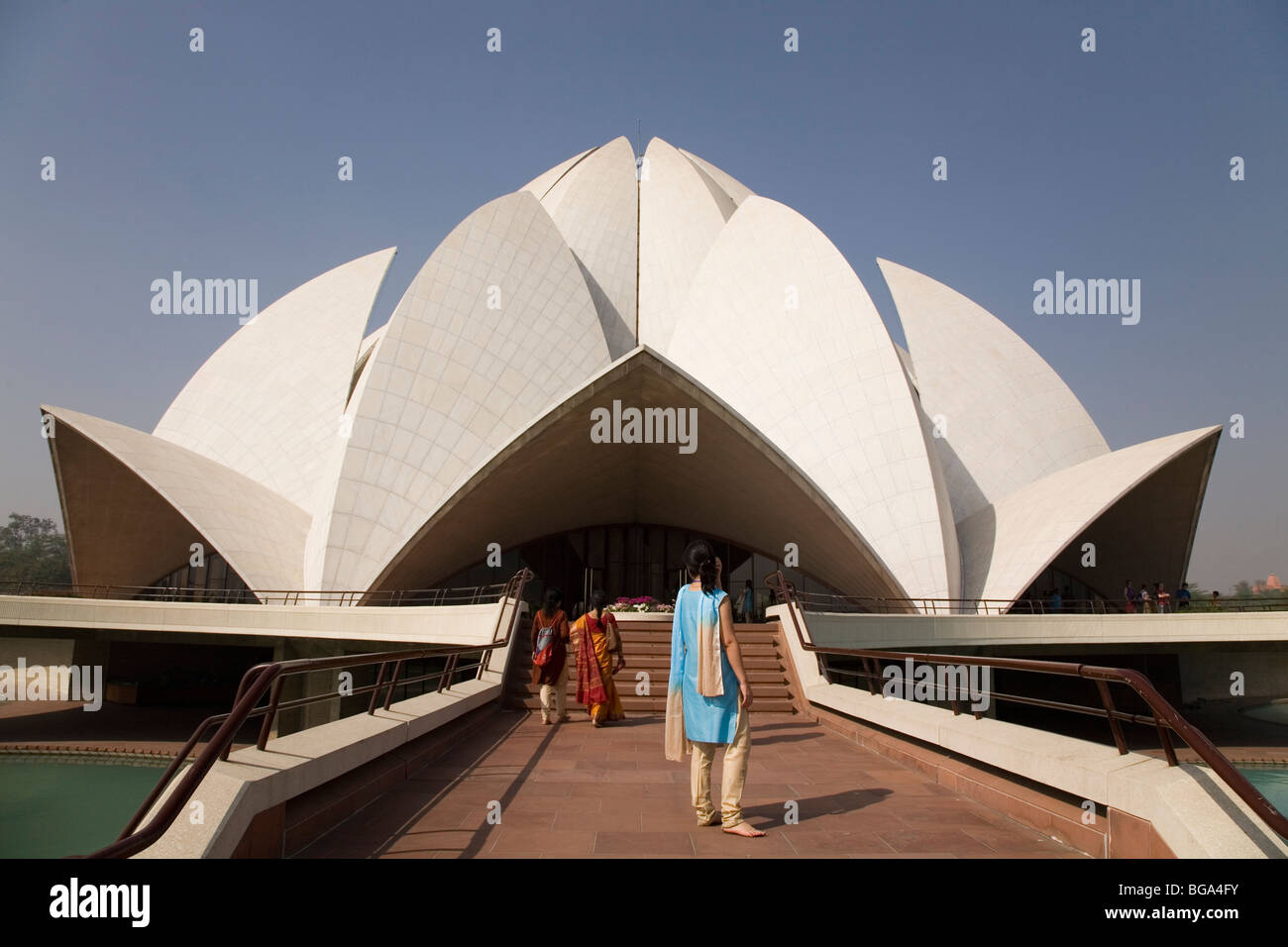 A woman looks towards the Bahai House of Worship (the Lotus Temple) in New Delhi, India. Stock Photo