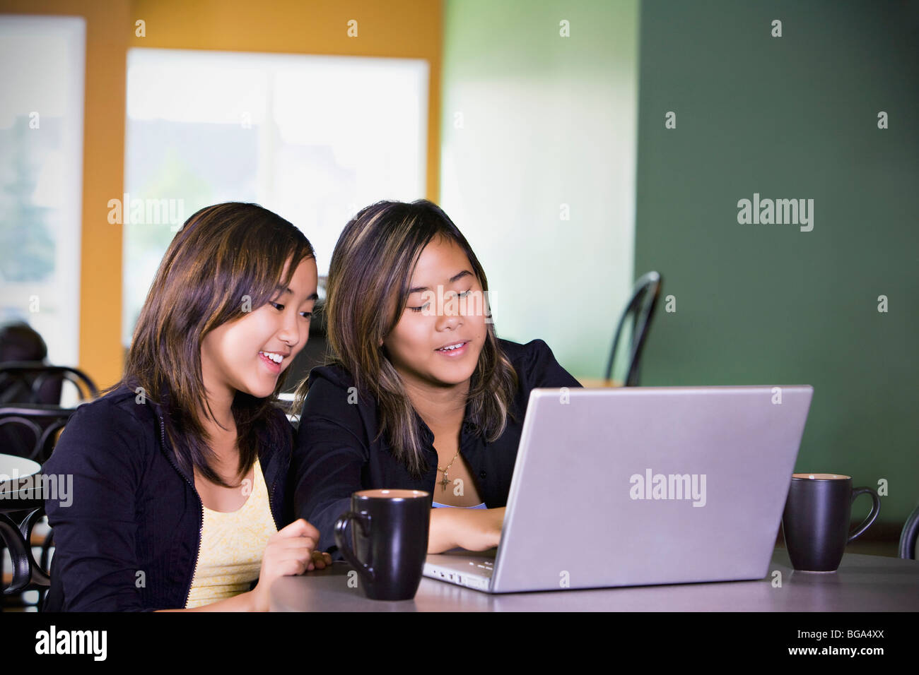Two girls on a laptop computer Stock Photo