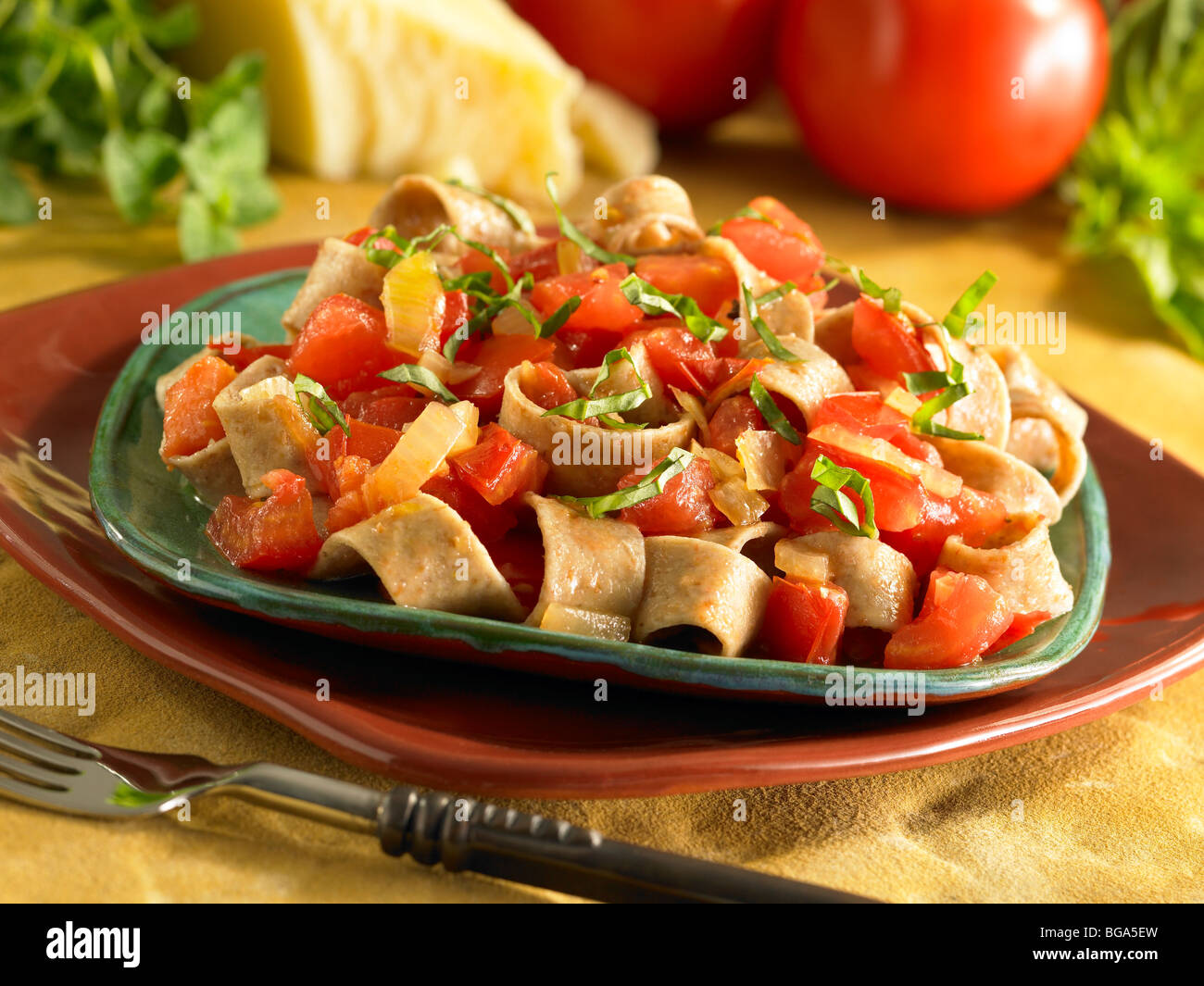 Chunky tomato basil onion pasta with whole wheat noodles Stock Photo