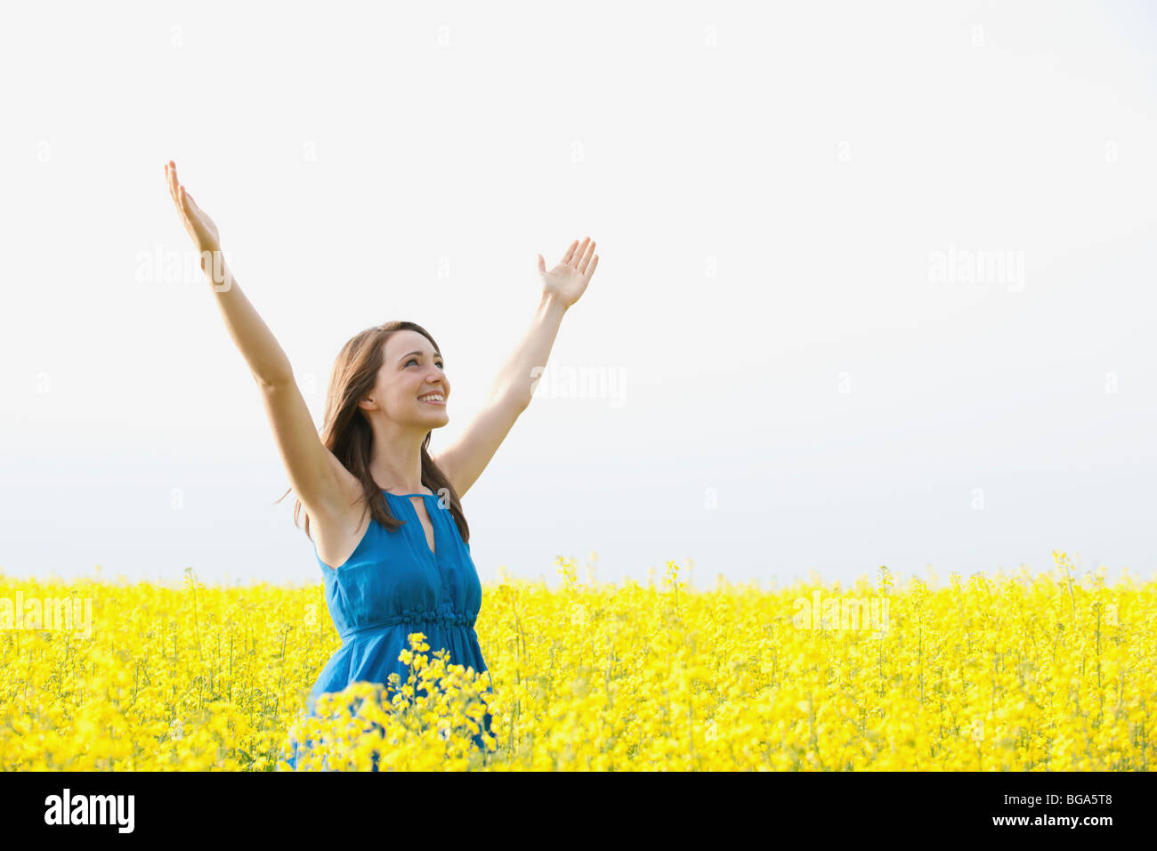 A young woman with arms raised Stock Photo Alamy