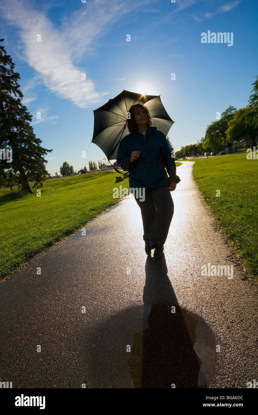 Woman with an umbrella; St. Albert, Alberta, Canada Stock Photo