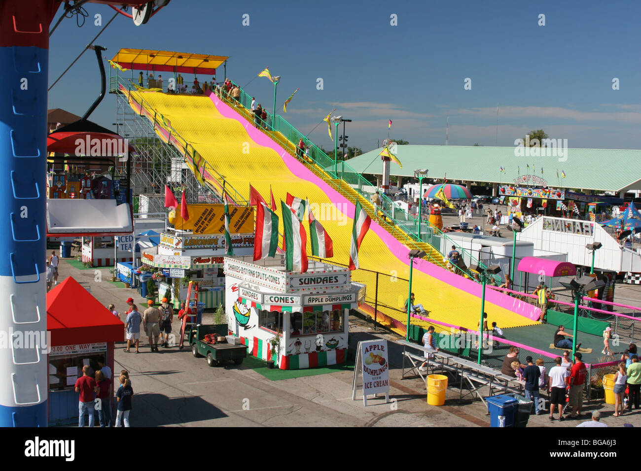 Slide Carnival Ride with Food Vendors. View from the Sky Glider cable car ride. Ohio State Fair. Columbus, Ohio, USA. Stock Photo