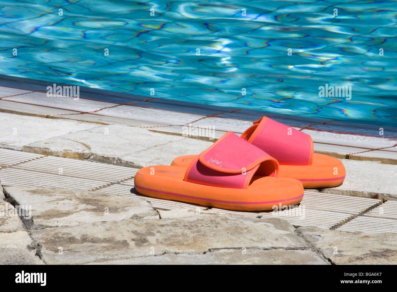 Beach shoes by swimming pool Stock Photo Alamy