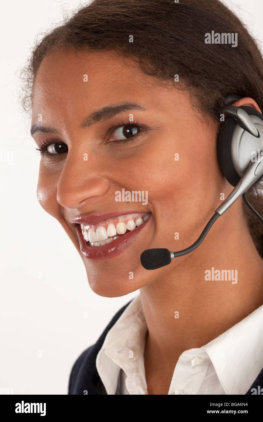 Closeup of young businesswoman wearing headset. Vertically framed shot. Stock Photo