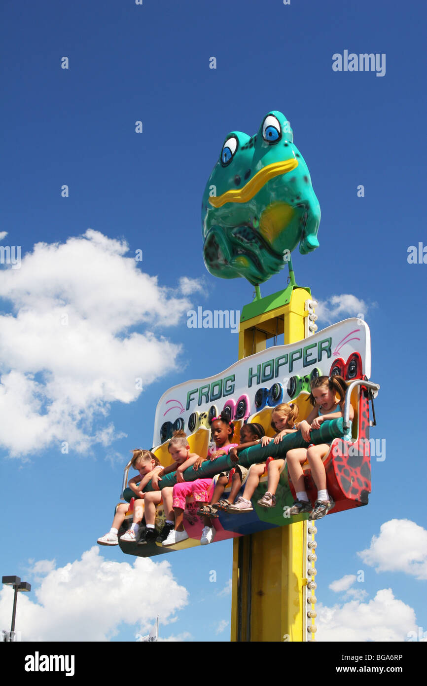 Girls on Frog Hopper Carnival Ride. Ohio State Fair. Columbus, Ohio, USA. Caucasian and Afroamerican girls. Stock Photo