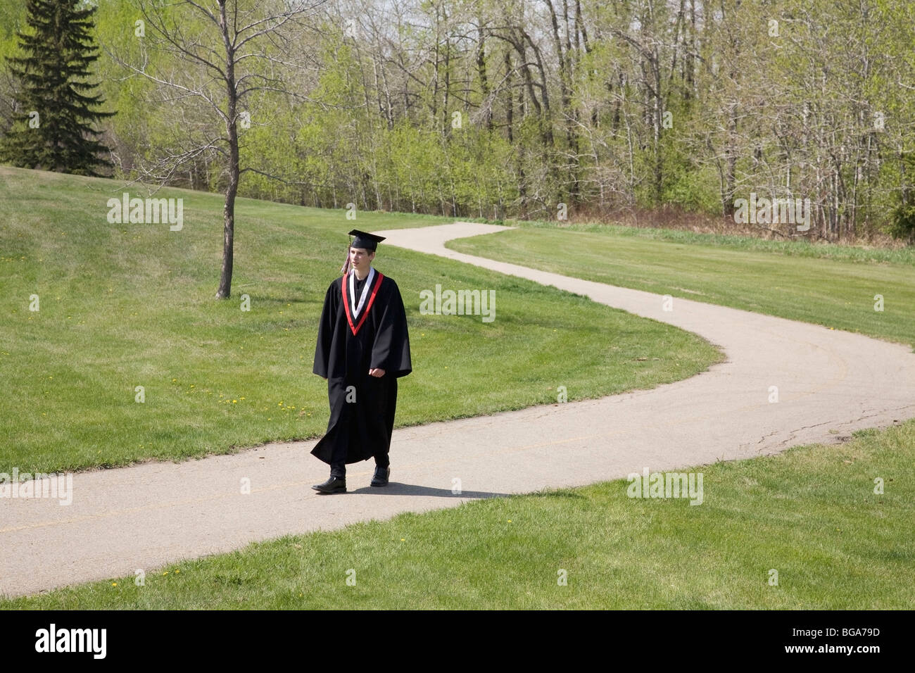 Graduate walking a path Stock Photo Alamy