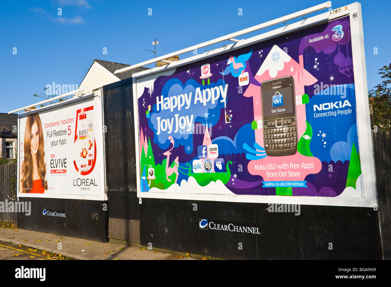 ClearChannel billboard site featuring poster for Nokia mobile phones next to Cheryl Cole L'Oreal ad in Newport South Wales UK Stock Photo