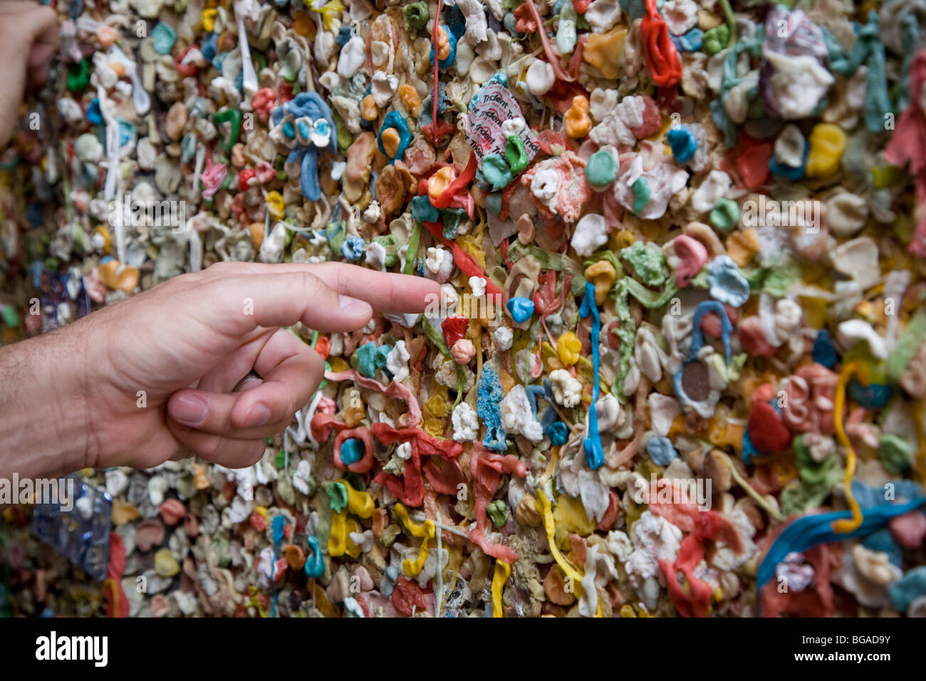 Man's hand pointing at the famous gum wall, Pike Place Market, Seattle Washington Stock Photo