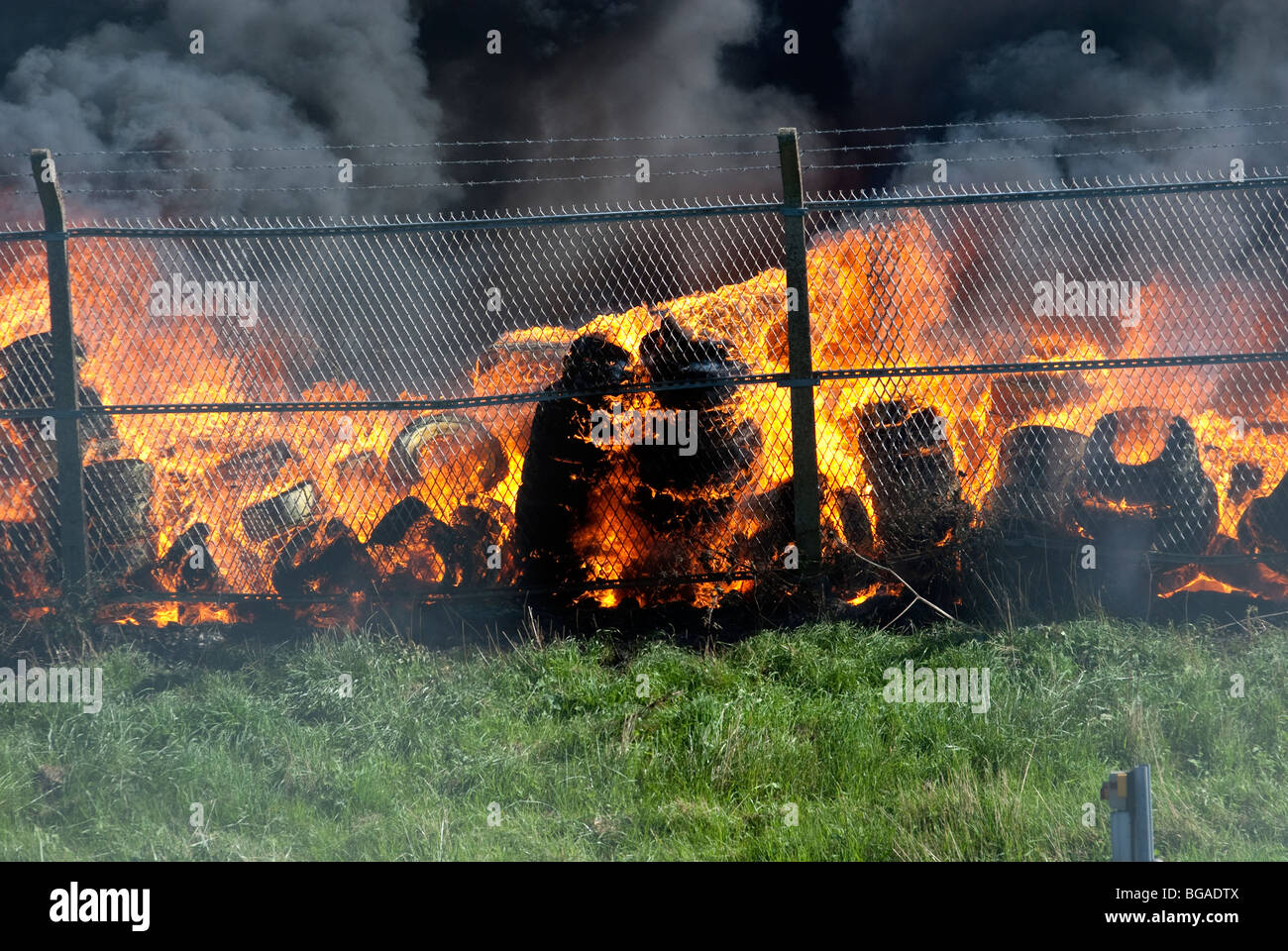 Large plumes of black smoke from large Tyre / Tire fire Stock Photo