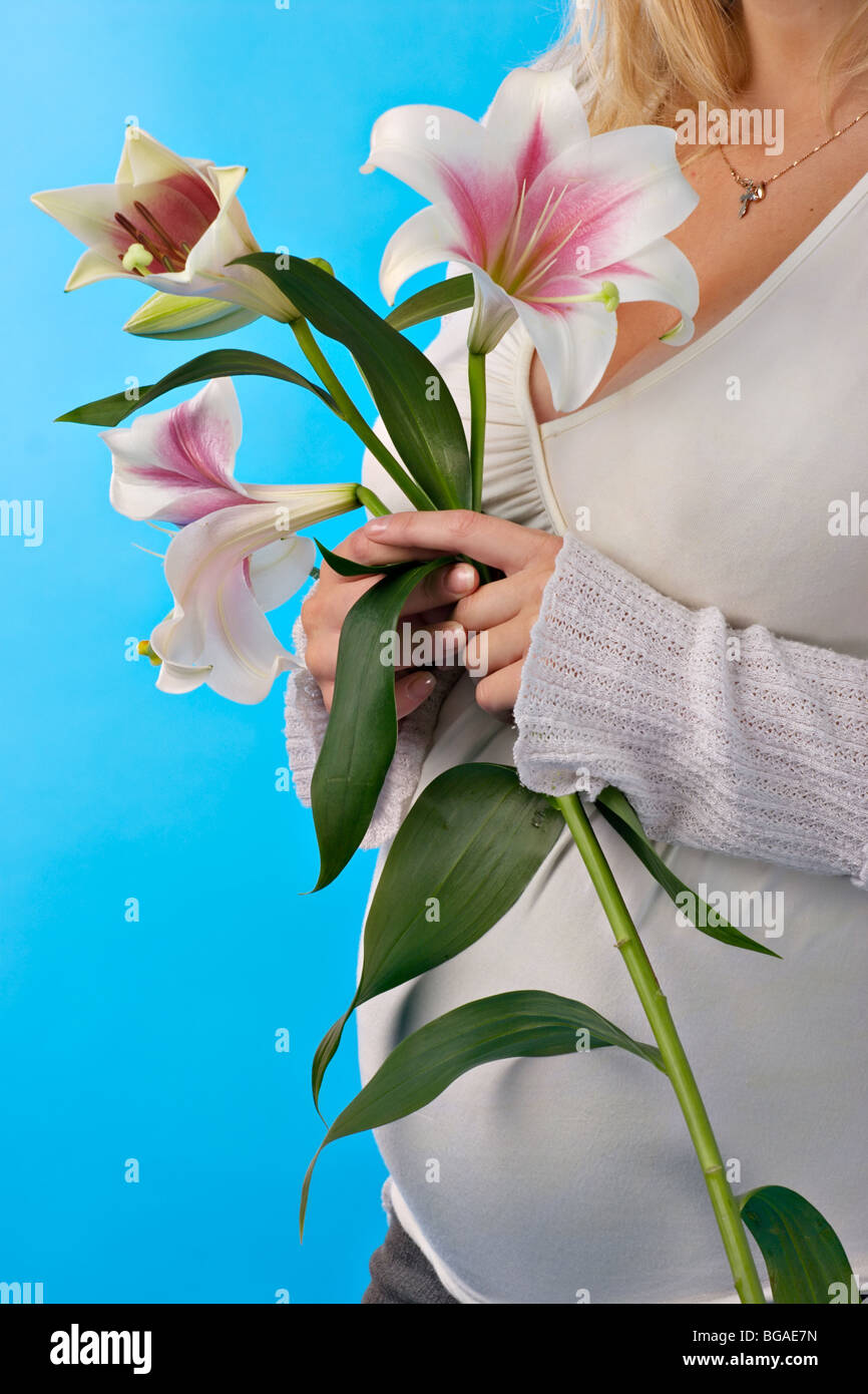 happy pregnant woman with lily in hands Stock Photo Alamy