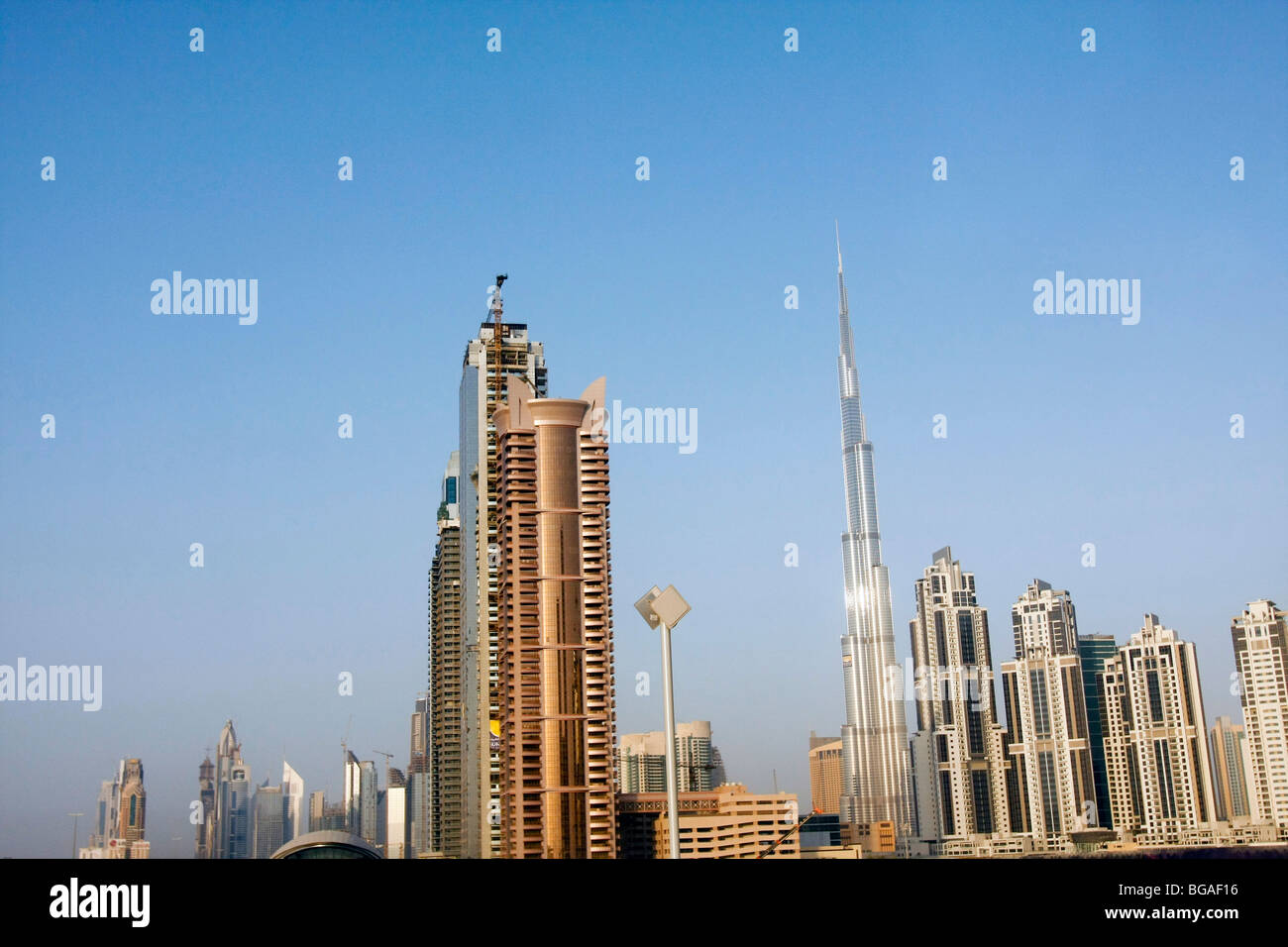 High-rise buildings at the Financial Center in Dubai. The tall narrow building is the Burj Tower, the world's tallest building. Stock Photo