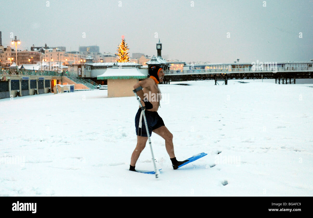 Members of Brighton Swimming Club head down the beach for their daily swim despite the heavy snowfall and freezing conditions - February 2009 Stock Photo