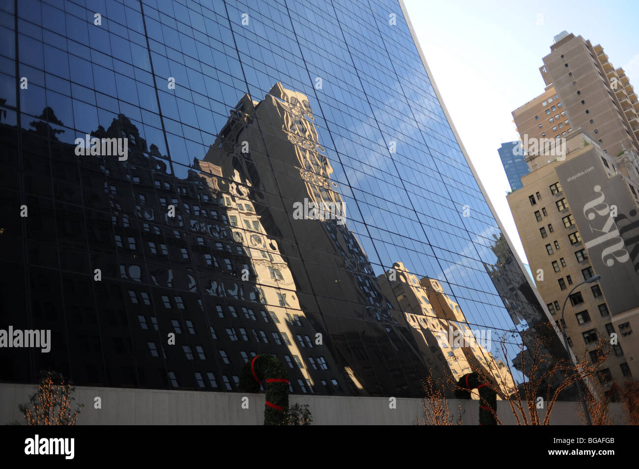 Reflections on a skyscraper glass fronted building in Midtown Manhattan New York USA Stock Photo
