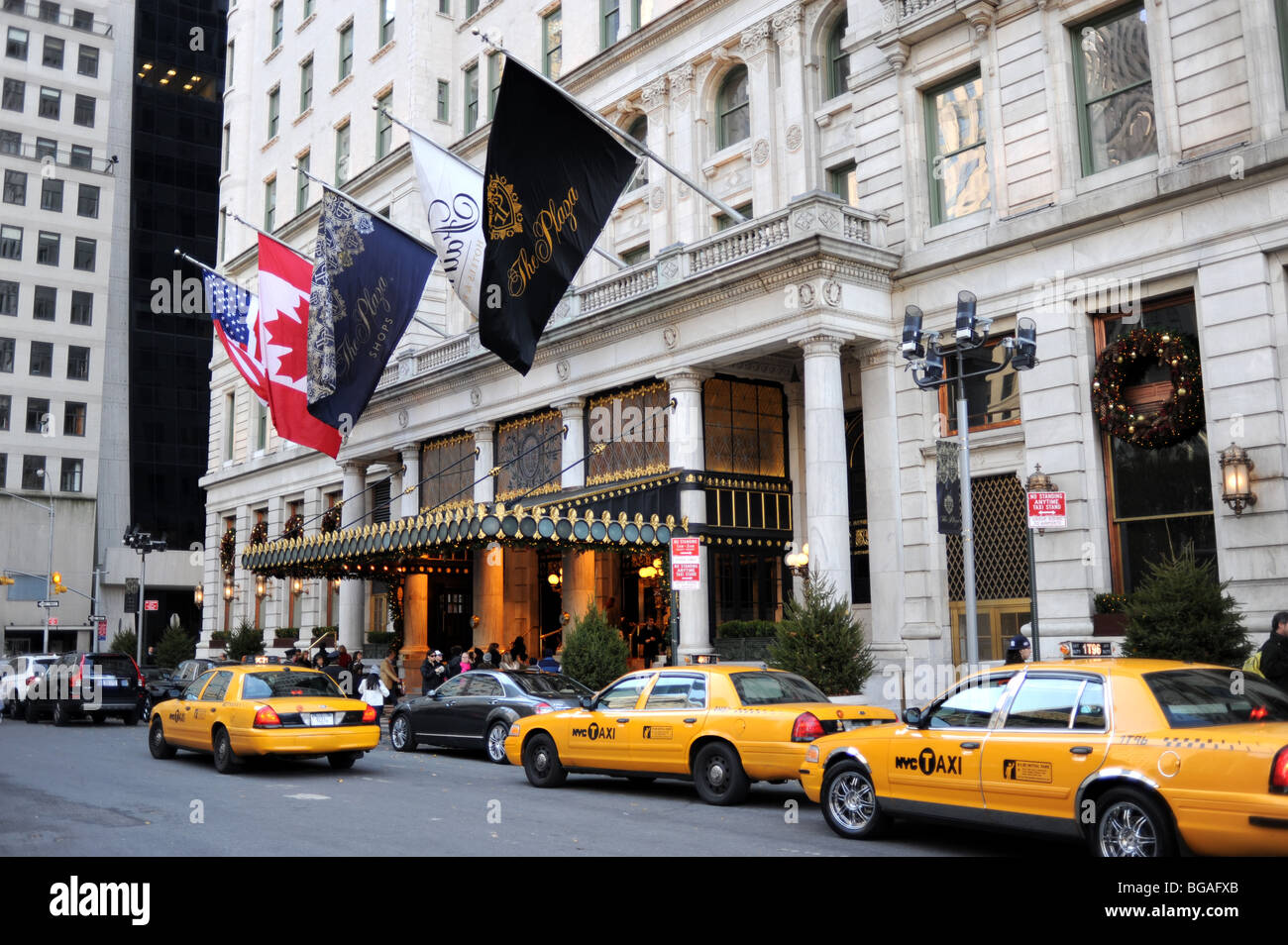 Yellow taxi cabs outside the Plaza Hotel near Central Park Manhattan New York USA Stock Photo