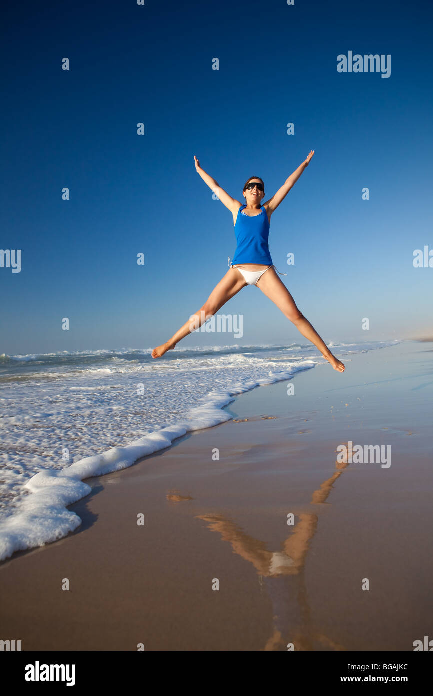 Beautiful young woman jumping on the beach Stock Photo Alamy