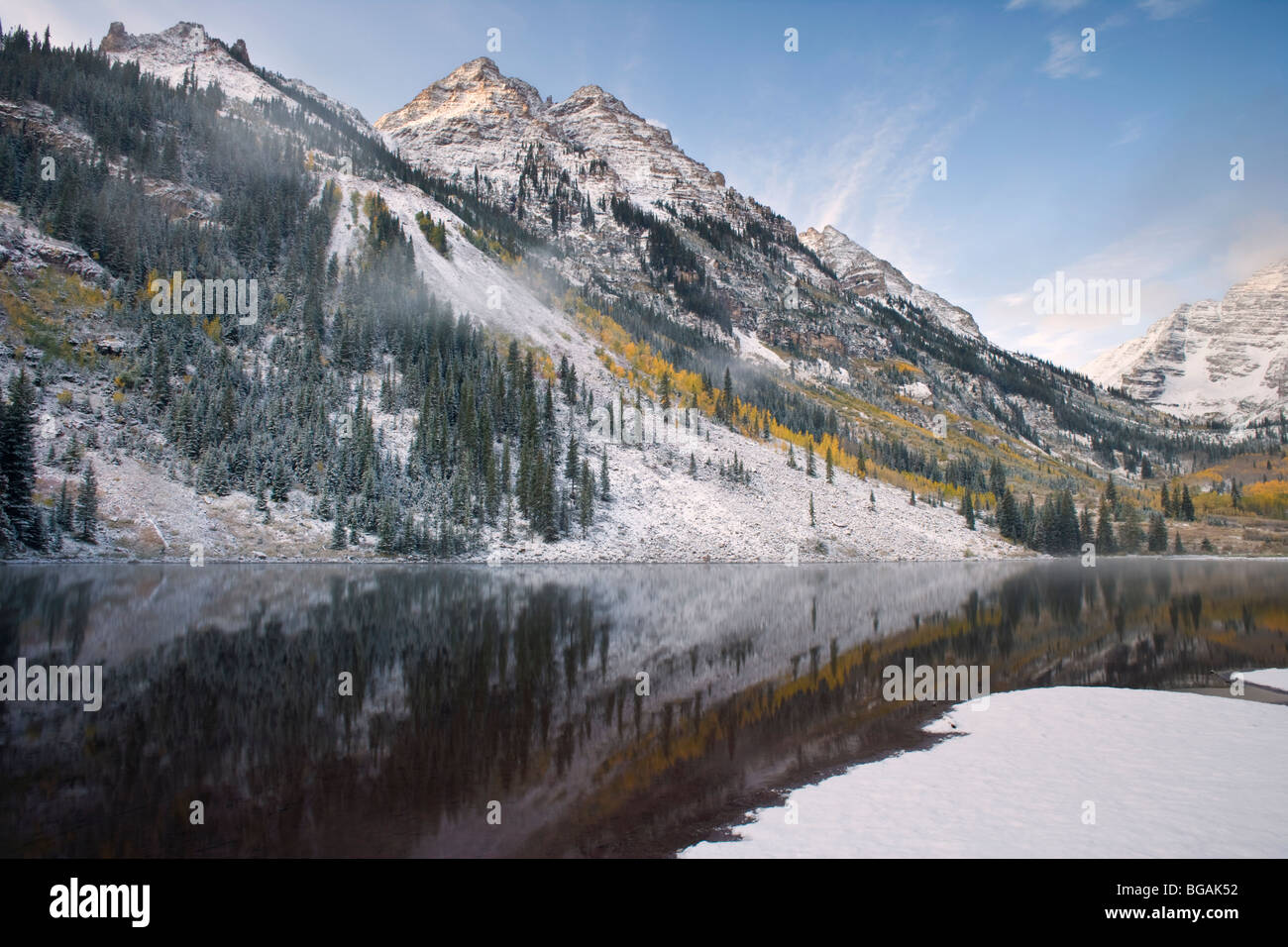 Mountains covered in snow and surrounding the Maroon Lake (CO) with ice formation in the foreground. Clear morning sky Stock Photo