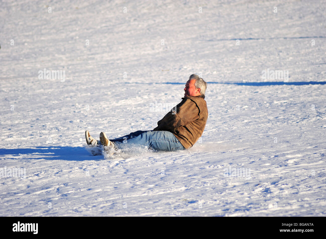 Man Sliding on snow Stock Photo Alamy