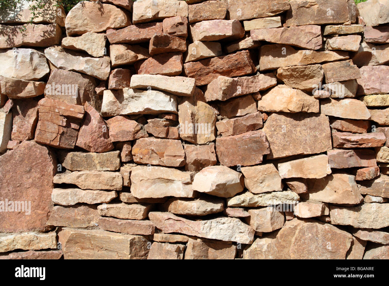 photo of wall of rock stones - background Stock Photo - Alamy