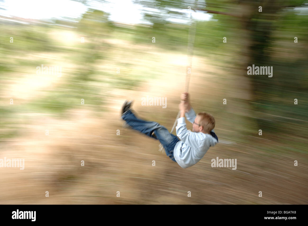 boy swinging on a rope Stock Photo Alamy