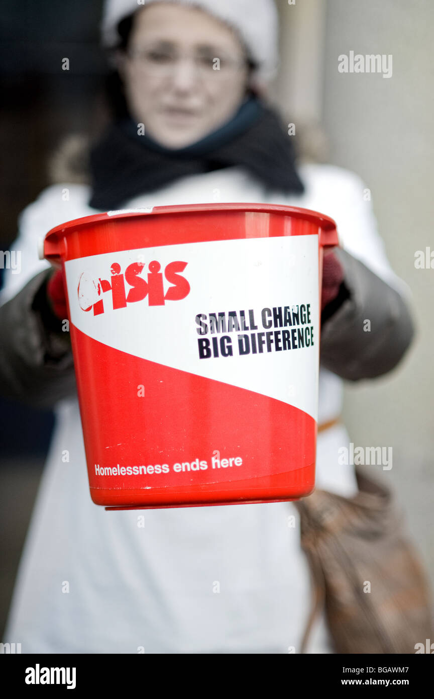 A bucket held by a Crisis at Christmas charity worker in London. Stock Photo