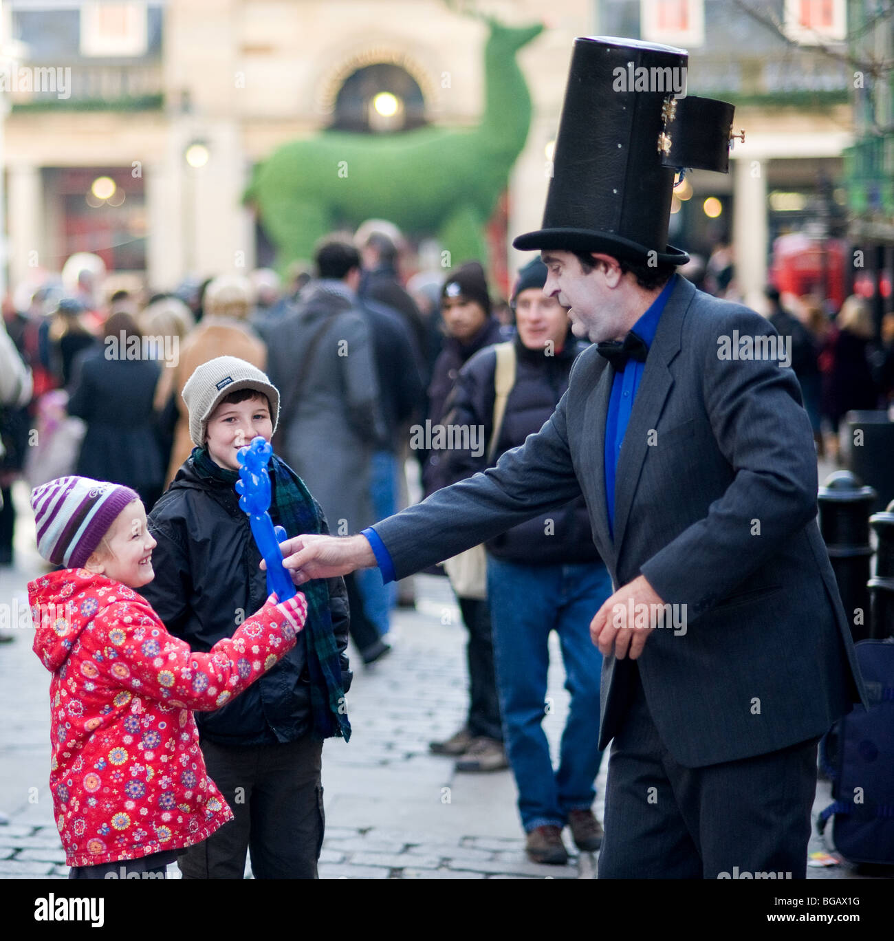 A street performer entertainer entertaining young children in Covent Garden London. Stock Photo