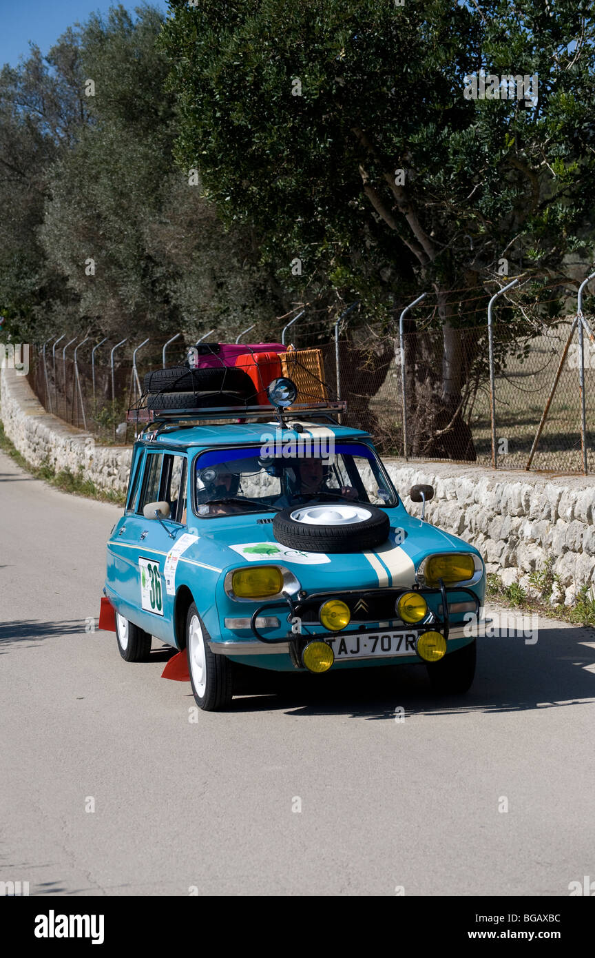 Blue 1970 Citroen Ami 8 classic supermini car being driven in a rally by famous television presenter James May. Stock Photo
