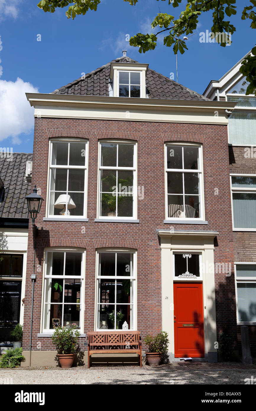 Dutch House exterior with bench and windows without curtains. Delft, Zuid, Holland Stock Photo