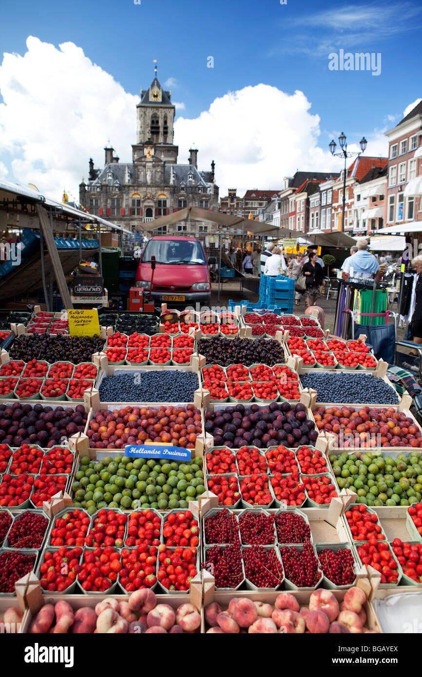 Colorful stall of berry fruits in wooden cases at the Dutch market in