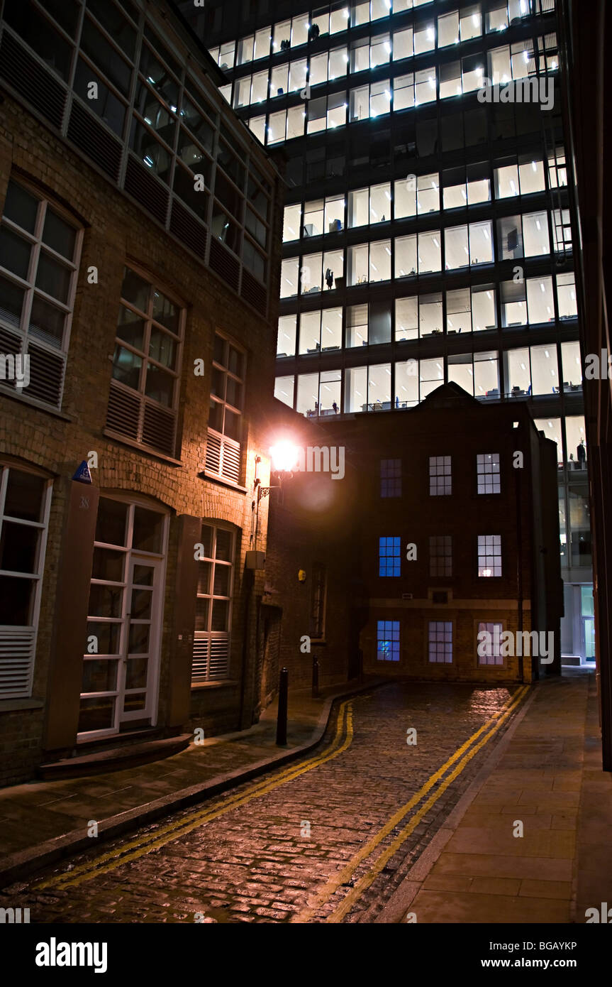 Spital yard spitalfields london with a lit office building behind in