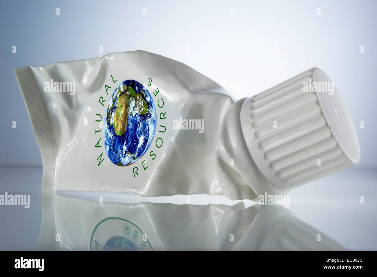 squeezed-out white tube marked with the words natural resources and a globe Stock Photo