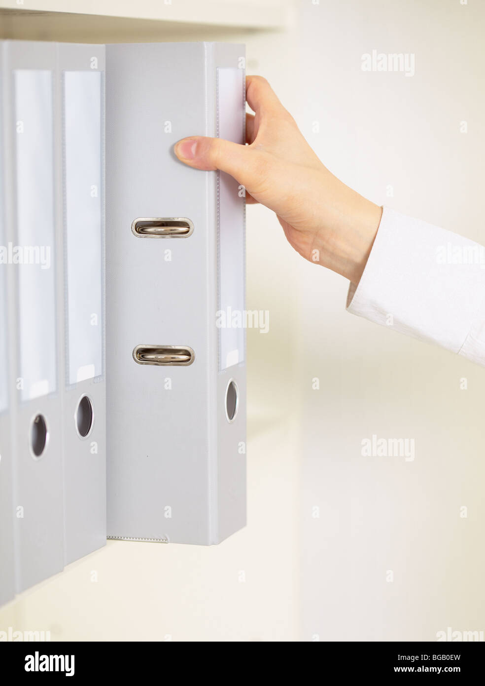 Folder with archival documents and a hand of the clerk Stock Photo
