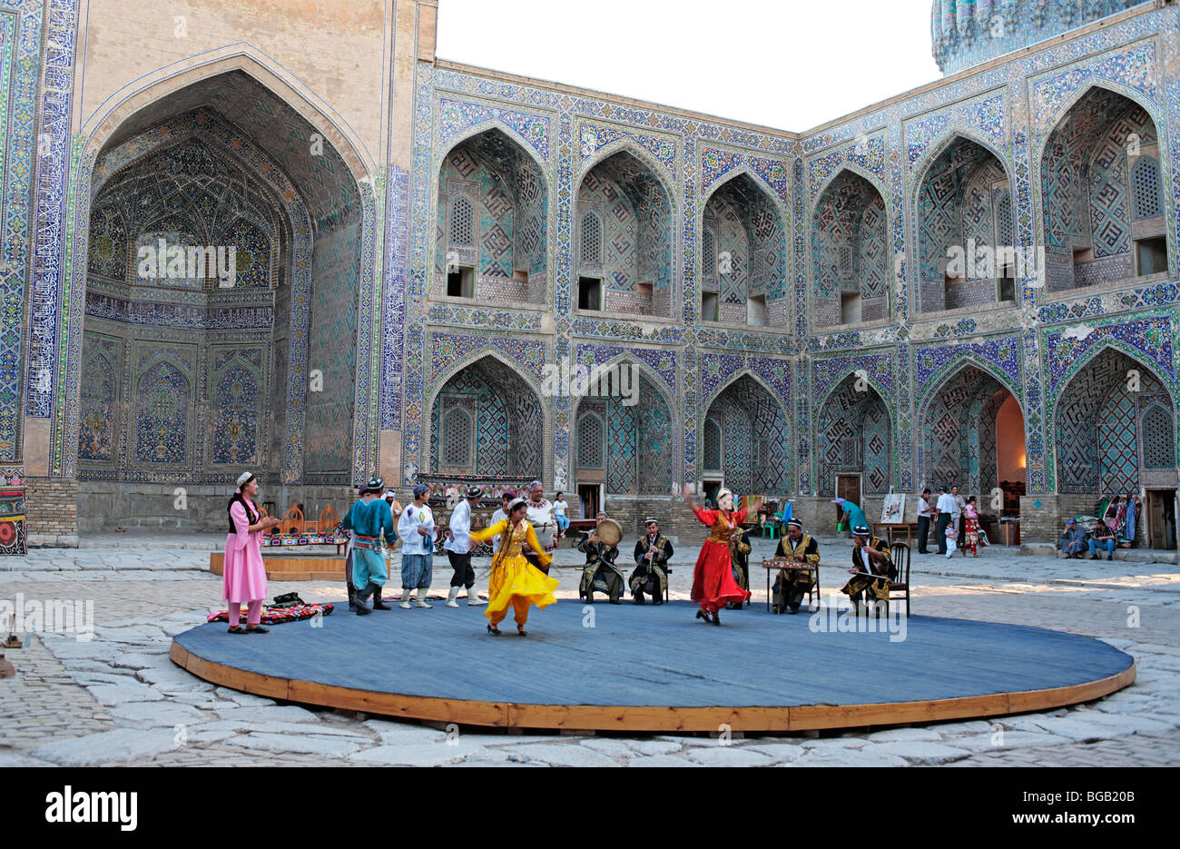 Uzbek folk show in the yard of Sher Dor Madrasah, Registan Square, Samarkand, Uzbekistan Stock Photo