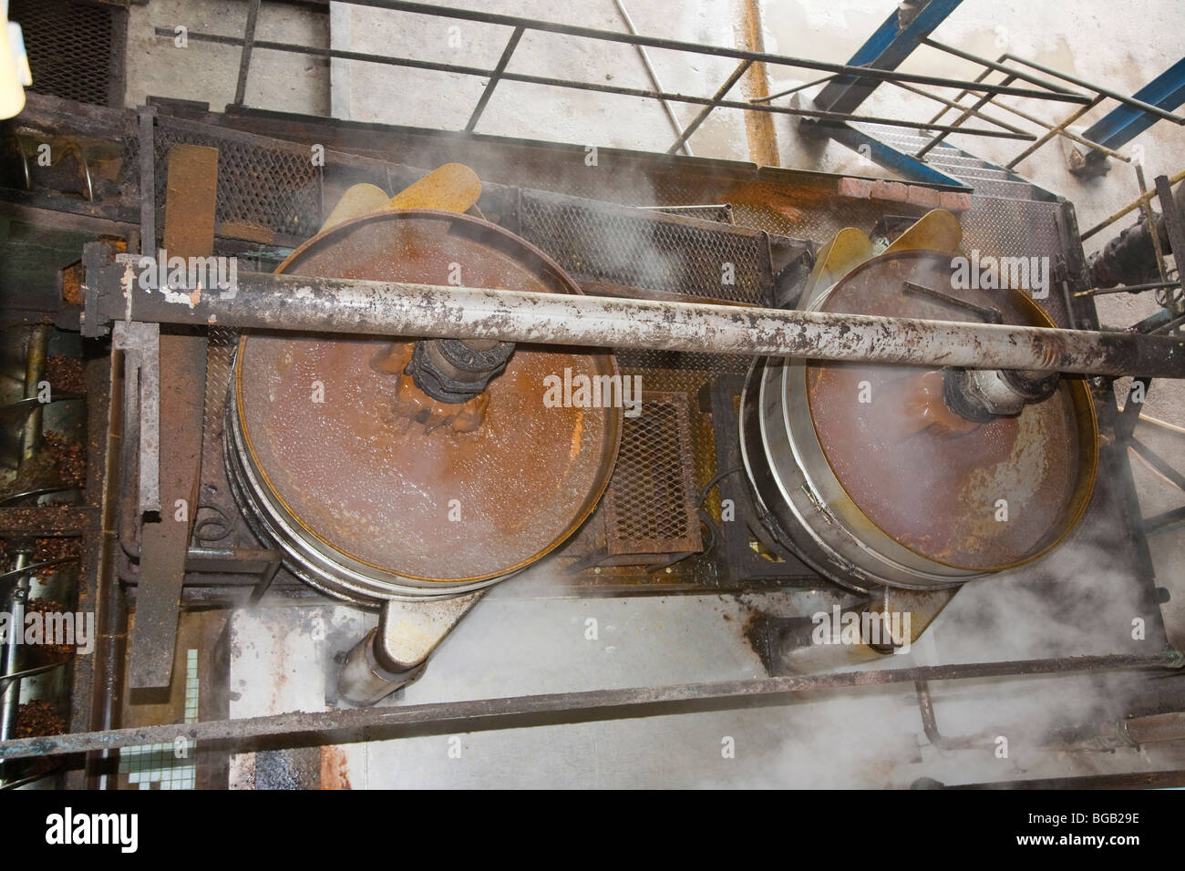 Looking down at steaming tubs of palm oil crude at the mill. The Sindora Palm Oil Mill, Johor Bahru, Malaysia Stock Photo
