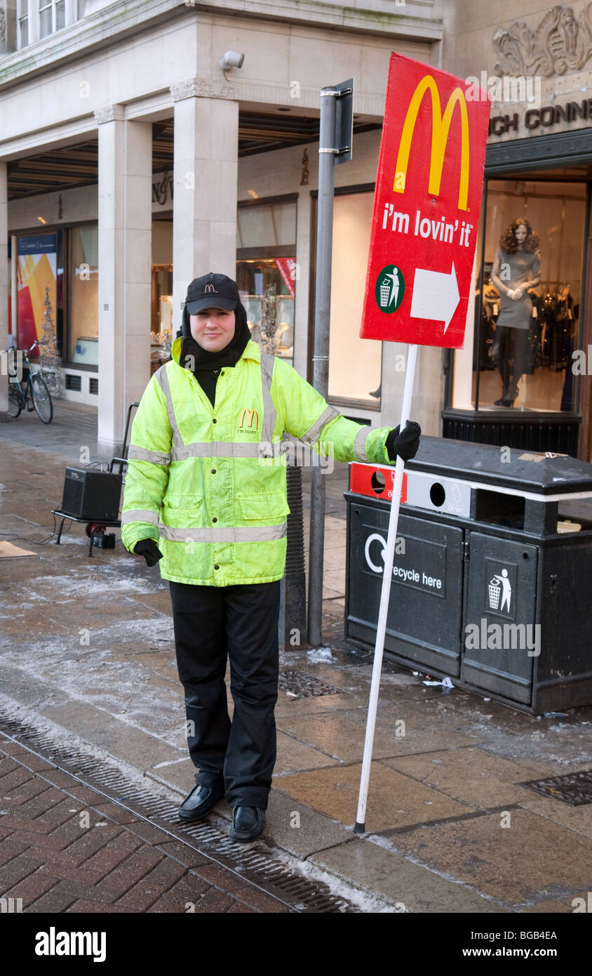 A man with a sign advertising McDonalds, Cambridge UK Stock Photo