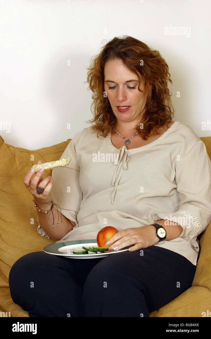 Plus sized woman on diet on sofa Stock Photo Alamy