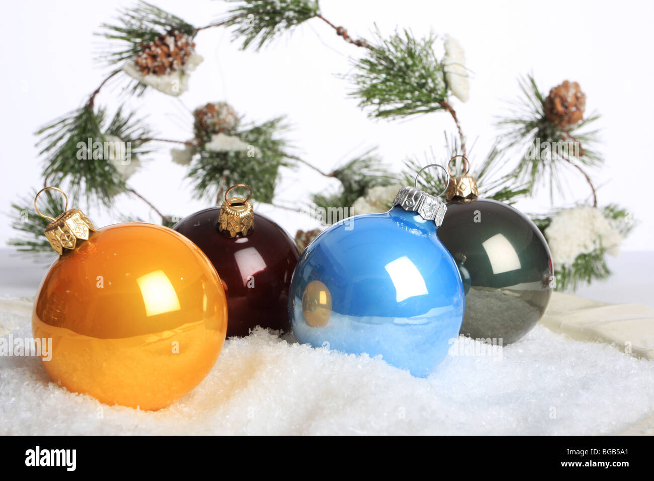 Colorful christmas ornaments on fake snow shot in studio Stock Photo