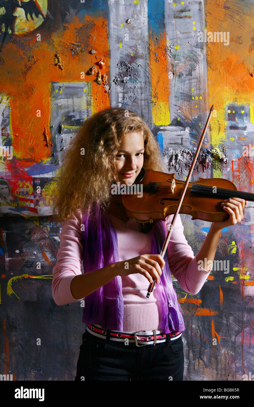 Young girl with violin on color graffiti background Stock Photo - Alamy