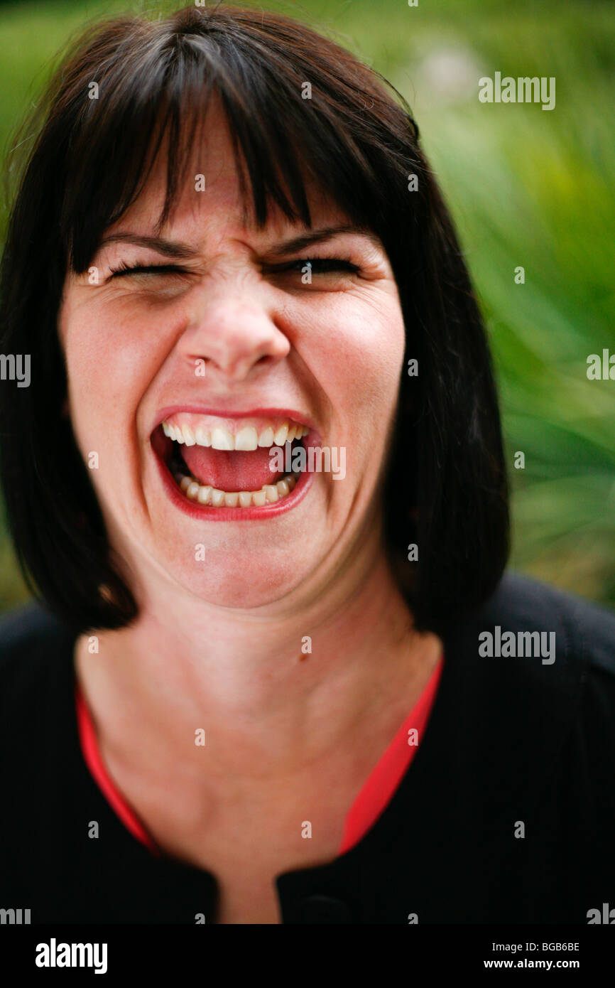 Brunette woman making crazy goofy silly faces. Stock Photo