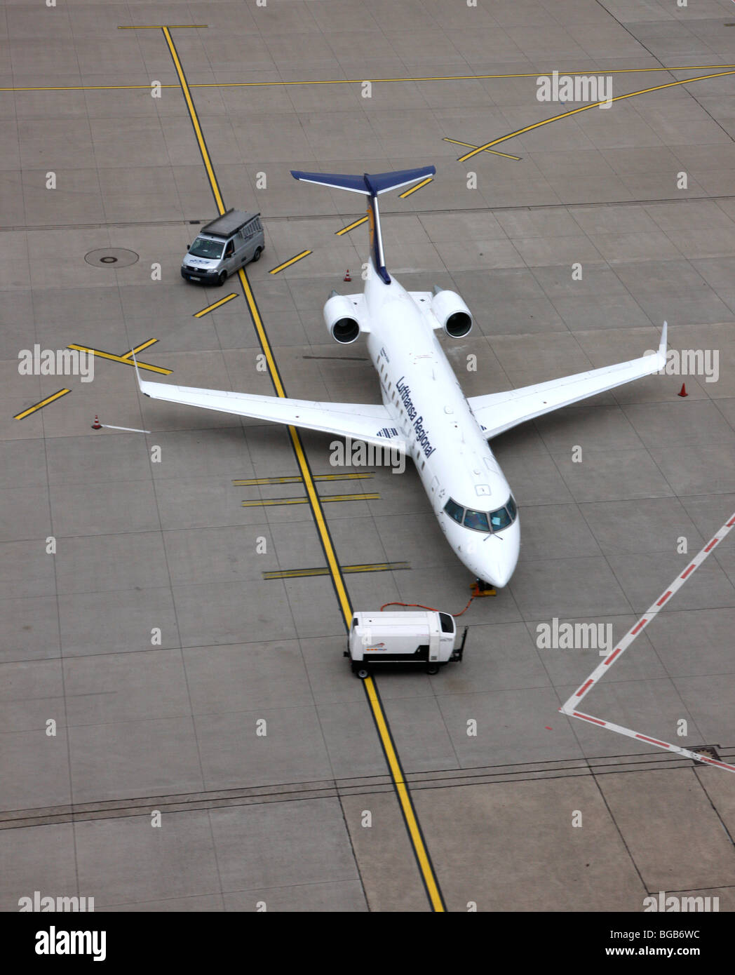 Plane on an airport taxi way, waiting for passengers. Stock Photo