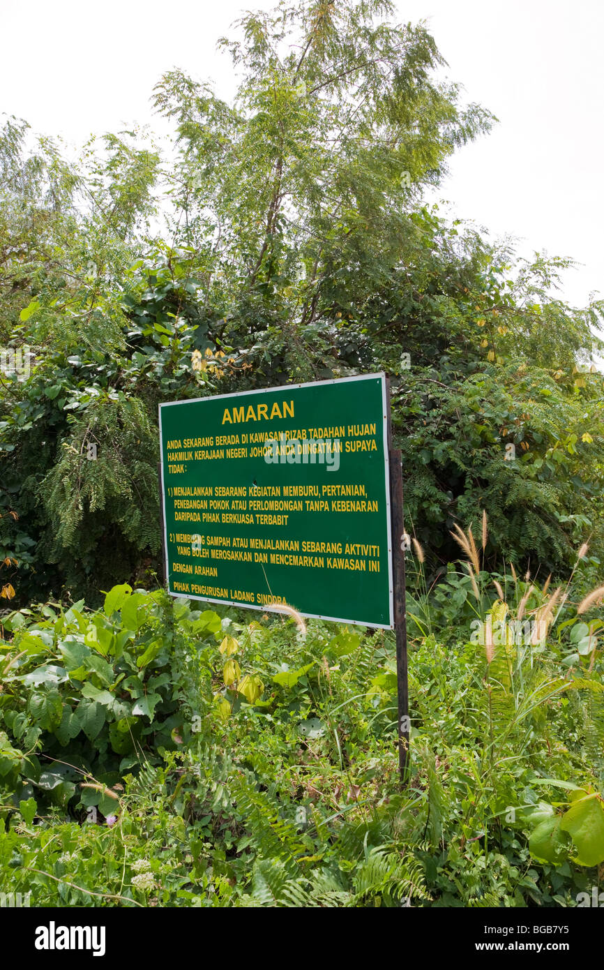 Forested watershed area with protection sign in Malay, the Sindora Palm Oil Plantation Stock Photo