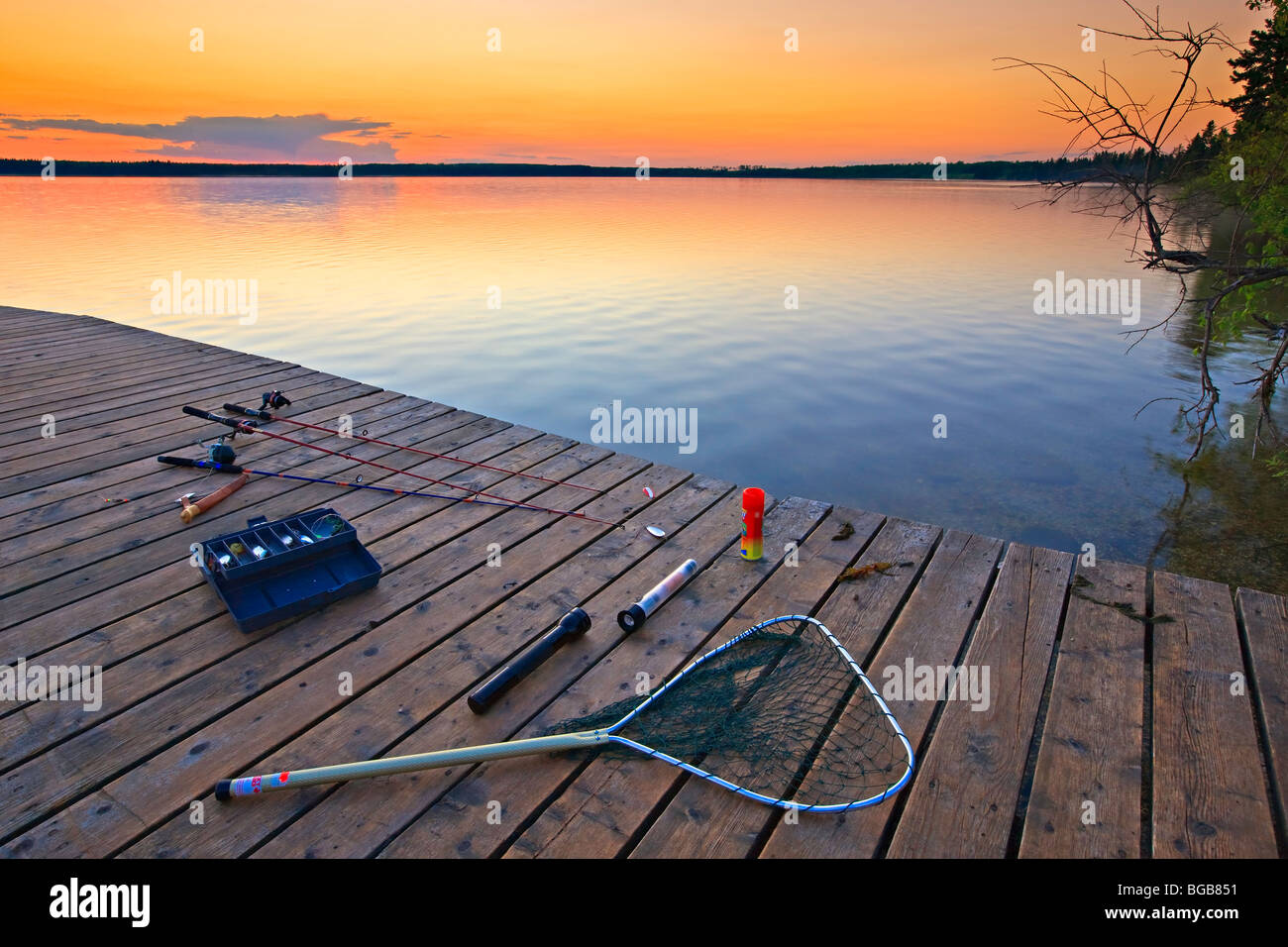 Fishing equipment laid out on the wharf at Lake Audy during sunset, Riding Mountain National Park, Manitoba, Canada. Stock Photo