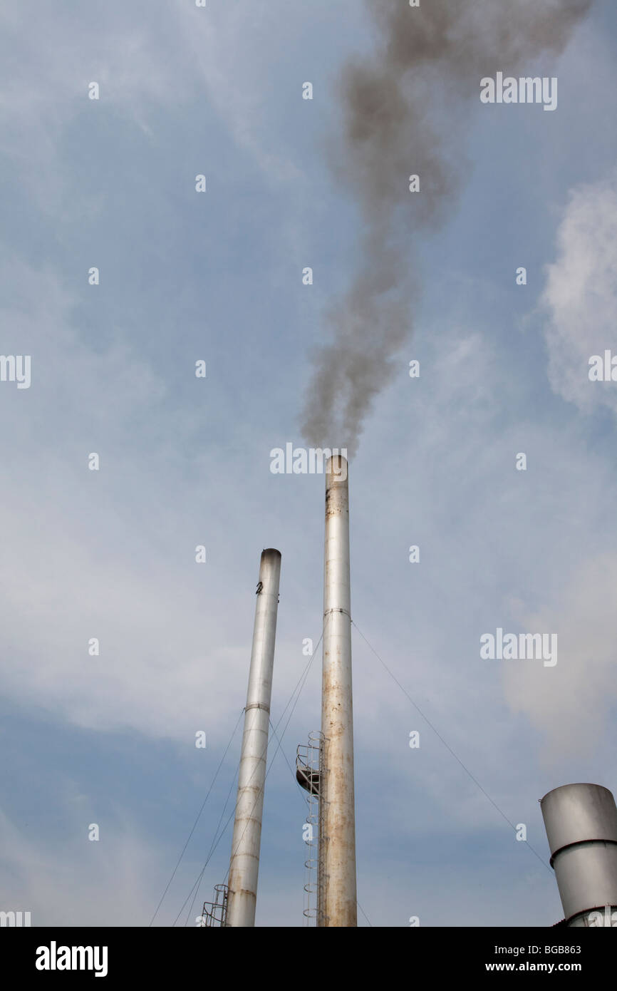 Smokestack emissions from palm oil mill. The Sindora Palm Oil Mill, Malaysia Stock Photo