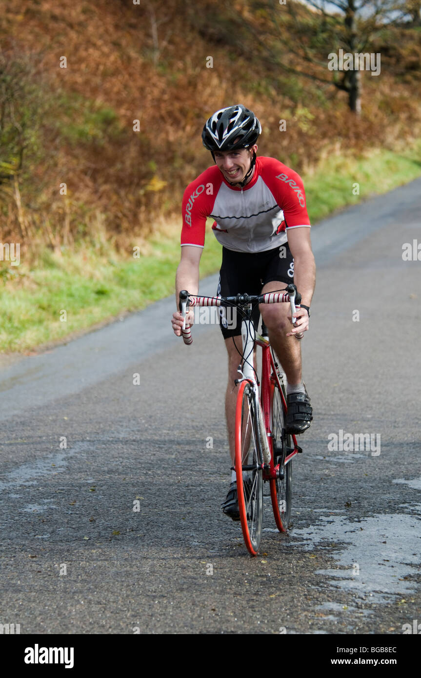 Endurance bicycle racing on Curbar Gap in the Peak District National Park Derbyshire Stock Photo