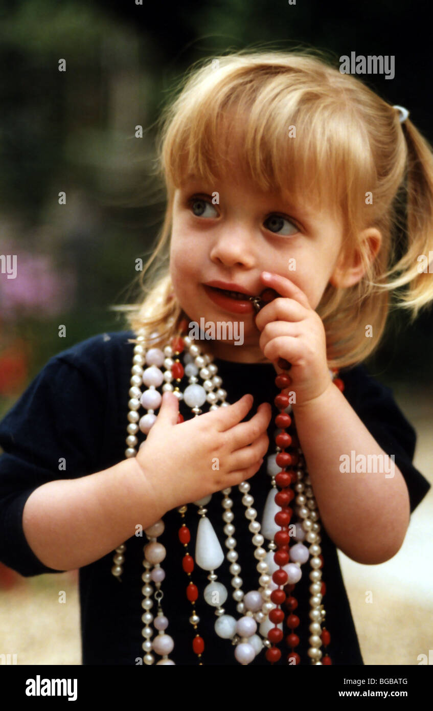 Photograph of young girl dressed up beads jewellery nervous kids Stock Photo