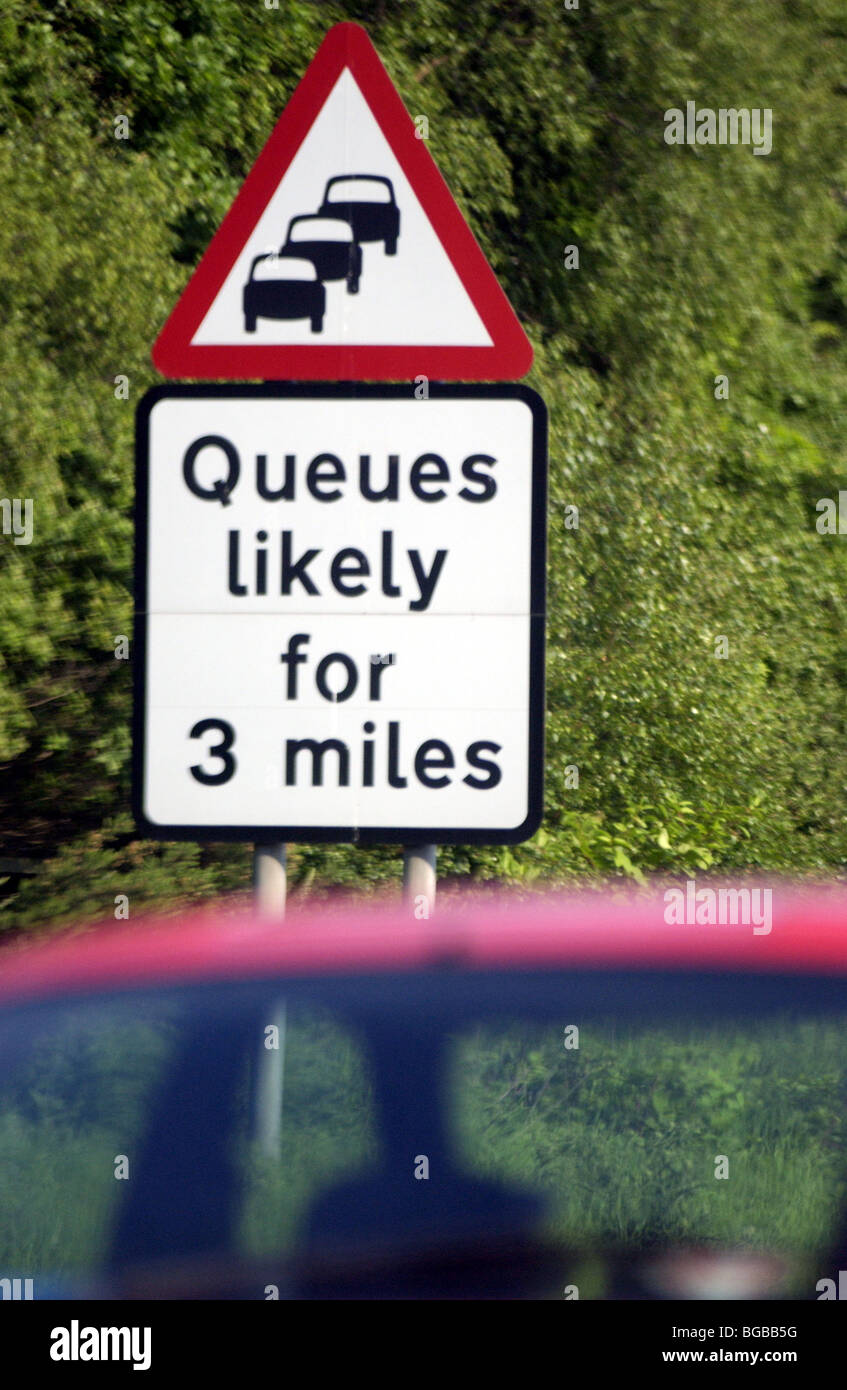 Royalty free photograph of road traffic sign warning of delays and traffic jams UK Stock Photo